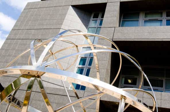 Armillary sphere sculpture with Oxford Cancer and Haematology Centre building behind