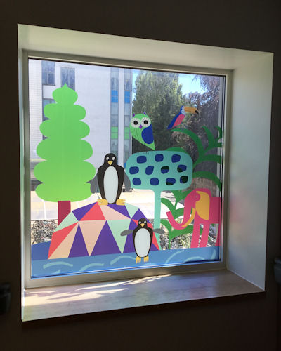 A square window with animal pictures creating stained-glass effect