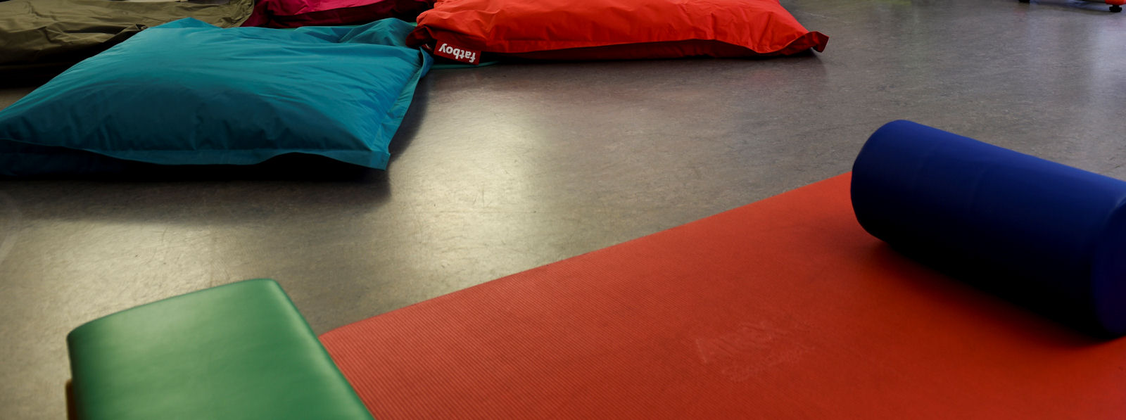 Large floor cushions on a polished gym floor