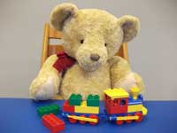 Teddy playing with a Duplo train
