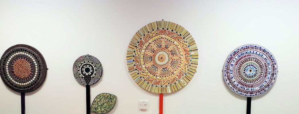 Round mosaics in a row on the wall