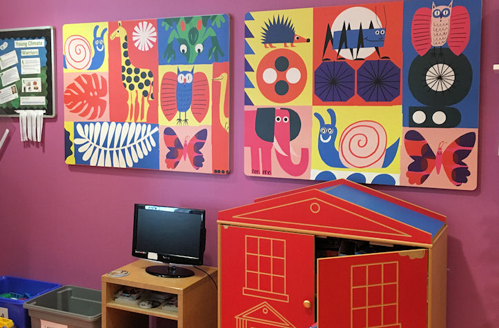 Bright wall panels in a play room, play house and computer screen below