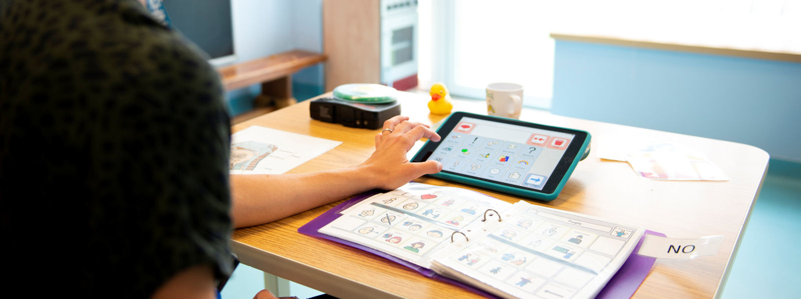 A hand interacting with a touch screen tablet computer