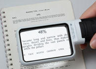 A magnifier held over the page of a book