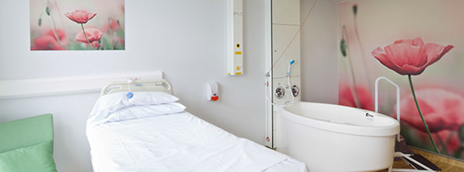 A bright hospital room with clean bed and bath