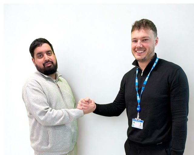 A patient (Waqar) and an OUH member of staff (Daley) shaking hands against a plain background