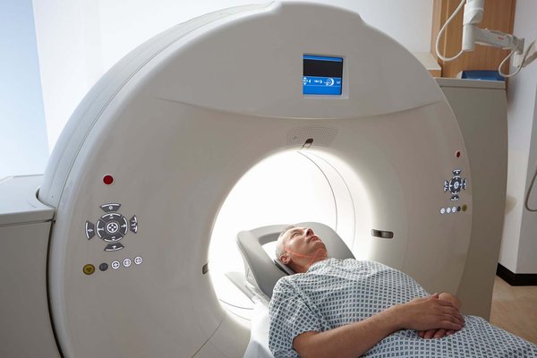 a man whose head is in a CT scanner