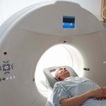 a man whose head is in a CT scanner