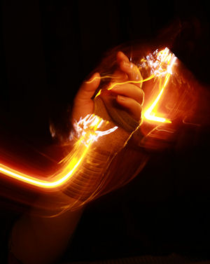 Hand holding a blurred light source