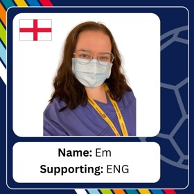 Young woman with long hair, with glasses, wearing face mask and lanyard, with caption 'Name: Em; Supporting: ENG'.