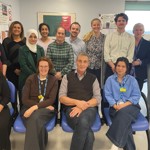 Group photo of healthcare staff together in a clinic room