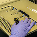 A gloved hand resting on a GridION machine