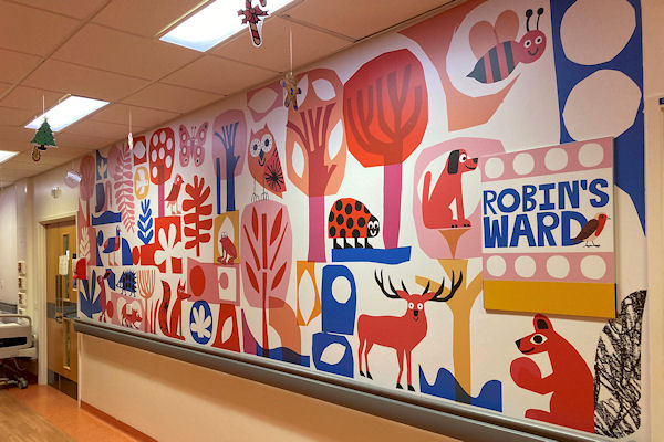 Hospital ward wall painted with large naive images of trees, animals and insects.