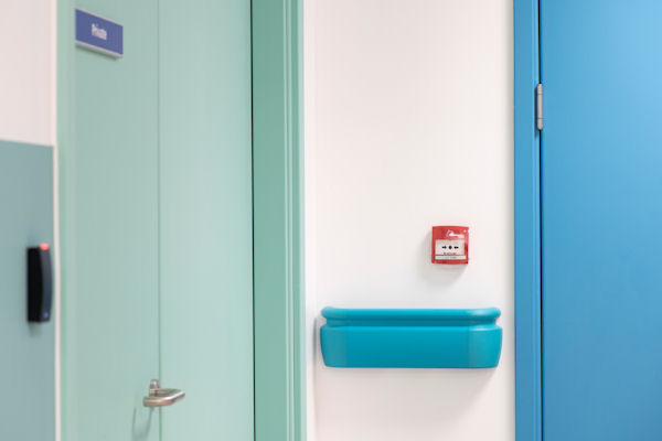 Two hospital room doors in different shades of blue.