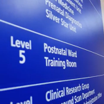 A blue sign with "Level 5, Postnatal Ward" in white letters