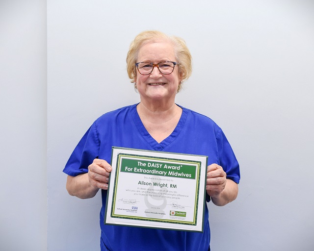 Alison Wright holding DAISY award certificate