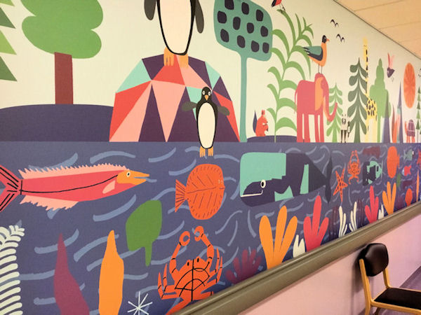 Hospital corridor wall painted with bright fish, trees, birds and animals.