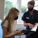 nurse speaks with trial participant at the EMCRF