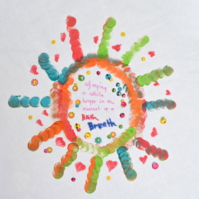 'Staying a while longer in the moment of a breath' written inside a circular pattern of painted dots with radiating stripes.