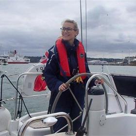 A person at the helm of a boat.