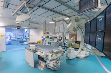 Ultra-modern clinical area with hi-tech bed and machinery - MRI scanner in next room