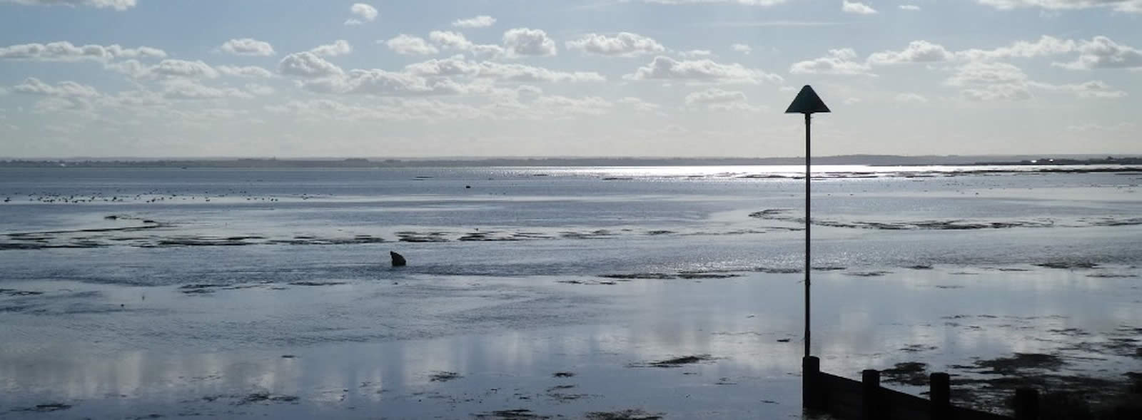 Seascape with calm sea and fluffy clouds