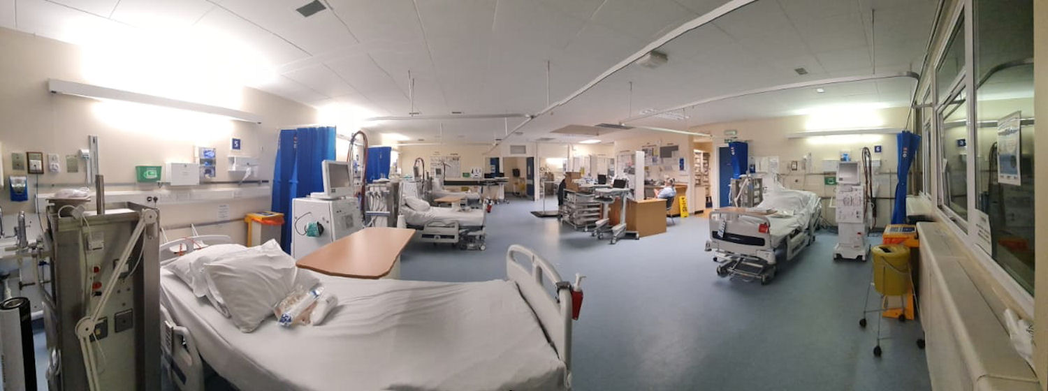 Empty hospital ward with clean stripped bed and electronic bedside equipment