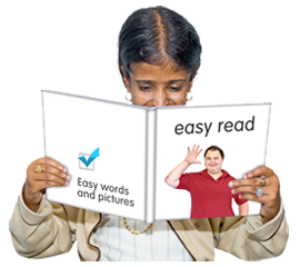 Woman reads leaflet 'Easy words and pictures - easy read'