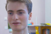 Young man with short hair in bright clinic room