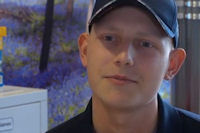 Young man in baseball cap in bright communal room