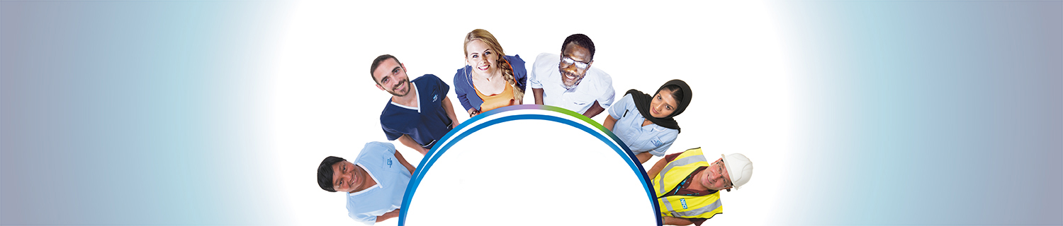 Six people in various NHS uniforms stand in a half circle looking up